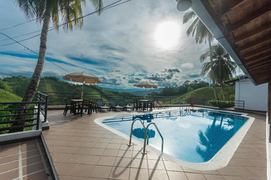 a swimming pool with a view of the mountains at Hotel Casa Encanto in Doradal