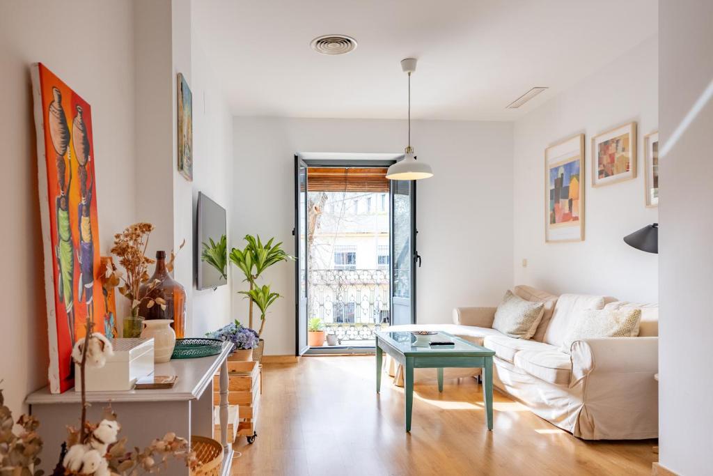 a living room with a couch and a table at Alma de San Bernardo in Seville