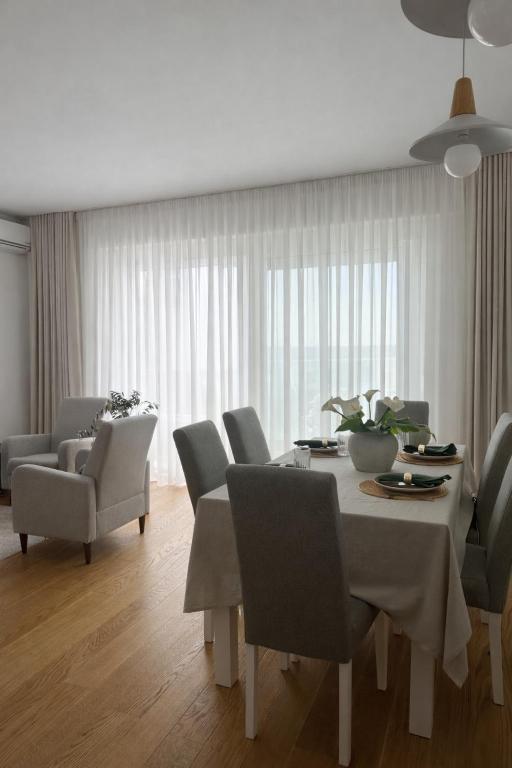 a dining room with a table and chairs at Libertina Rafailovici in Rafailovici