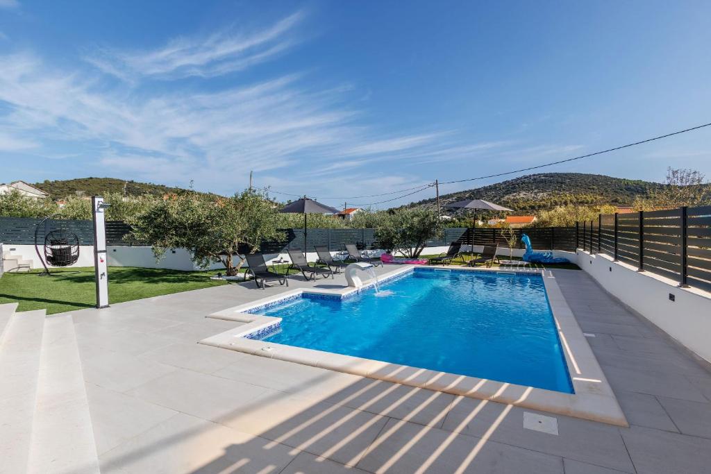 a swimming pool on the roof of a house at Villa dal' Mares in Vinišće