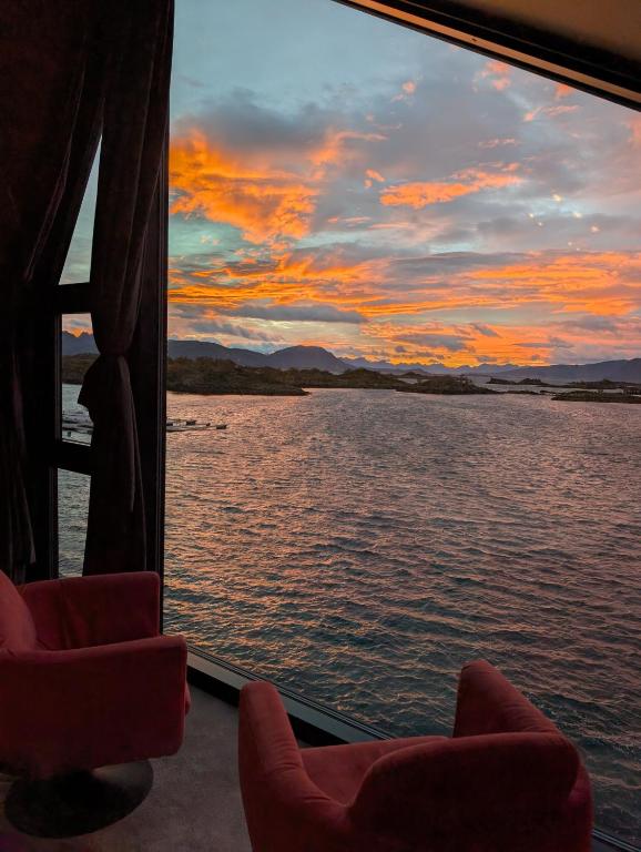 a view of a sunset from a ferry window at Ringstad Resort in Bø
