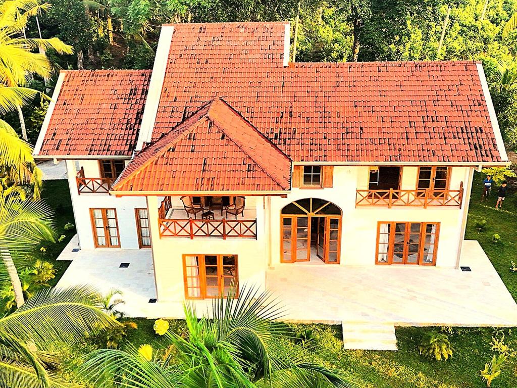 an aerial view of a house with a red roof at Luxury Cannelle lake villa in Hikkaduwa