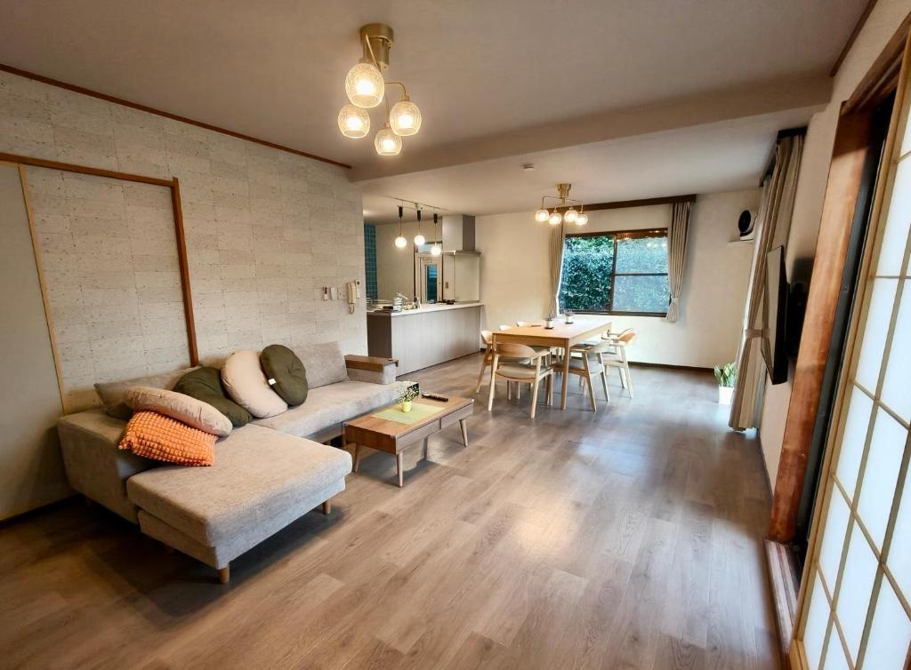 a living room with a couch and a table at Fuka in Beppu -New Open January2026 in Beppu