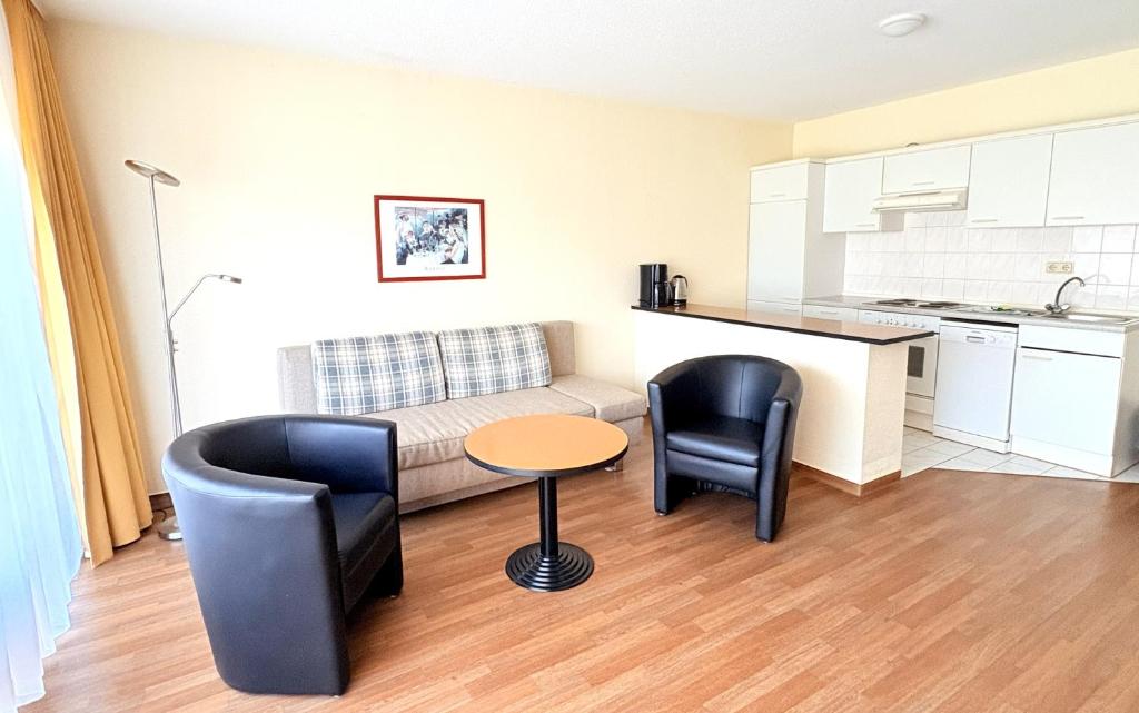a living room with a couch and chairs and a table at Boddenhof Apartment 44 - Terrasse, Hund willkommen in Buschvitz