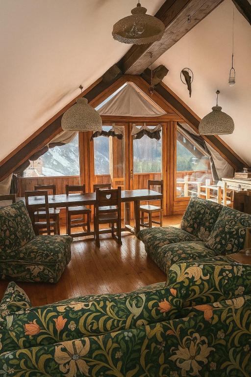 a living room with a table and a couch at La Grangia - mountain loft in Rollieres