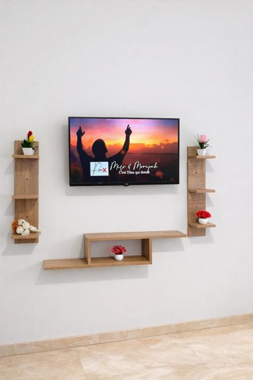 a flat screen tv hanging on a wall at Diamonds in Rabat