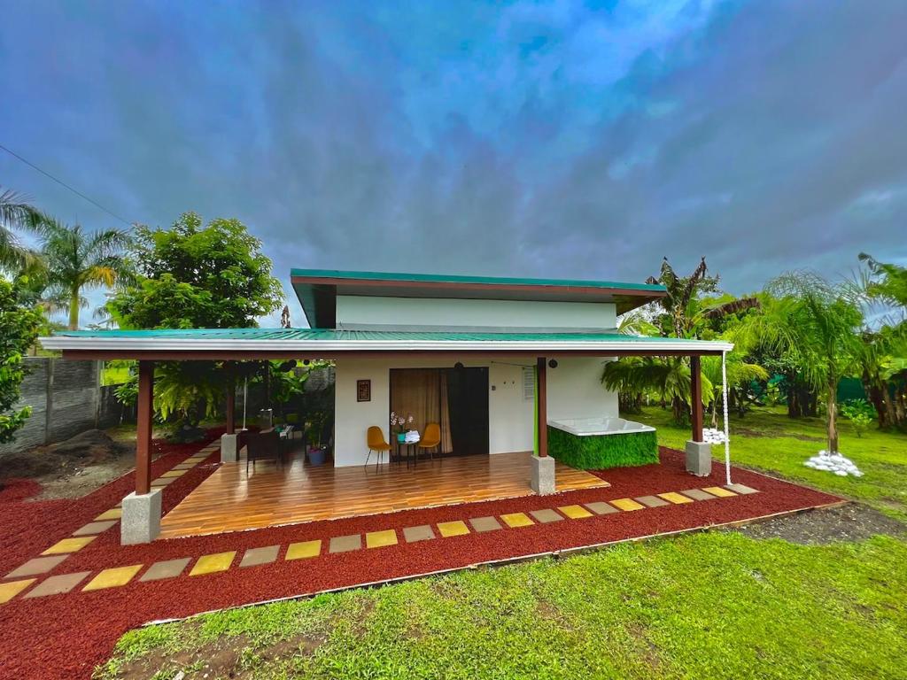 a house with a wooden deck in front of it at Sassy Sloth Villa in Fortuna