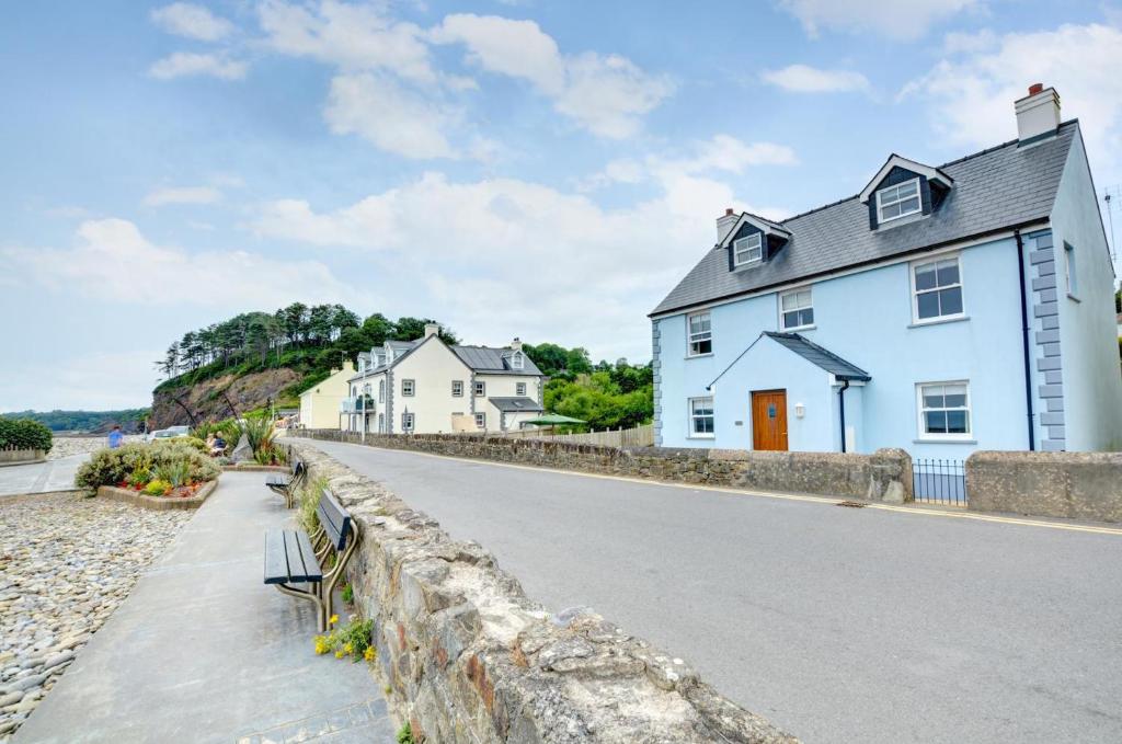a white house on the side of a road at 5 Bed in Amroth oc-pw9067 in Amroth