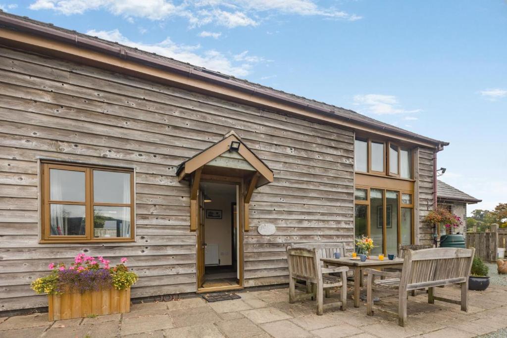 a wooden house with a table and two chairs at 4 Bed in Builth Wells oc-39473 in Builth Wells