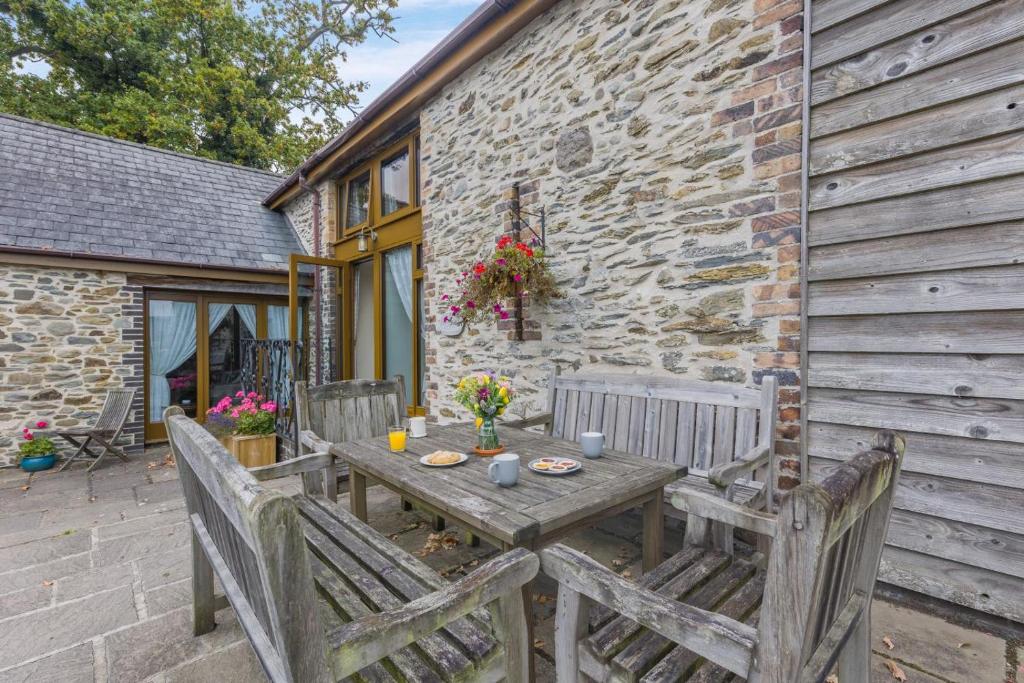 a wooden table and chairs on a patio at 4 Bed in Builth Wells oc-39461 in Builth Wells
