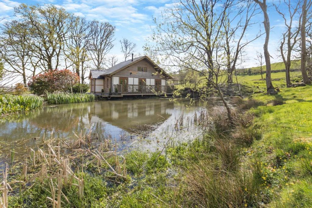 a house with a pond in front of it at 2 Bed in Caersws oc-waa345 in Trefeglwys