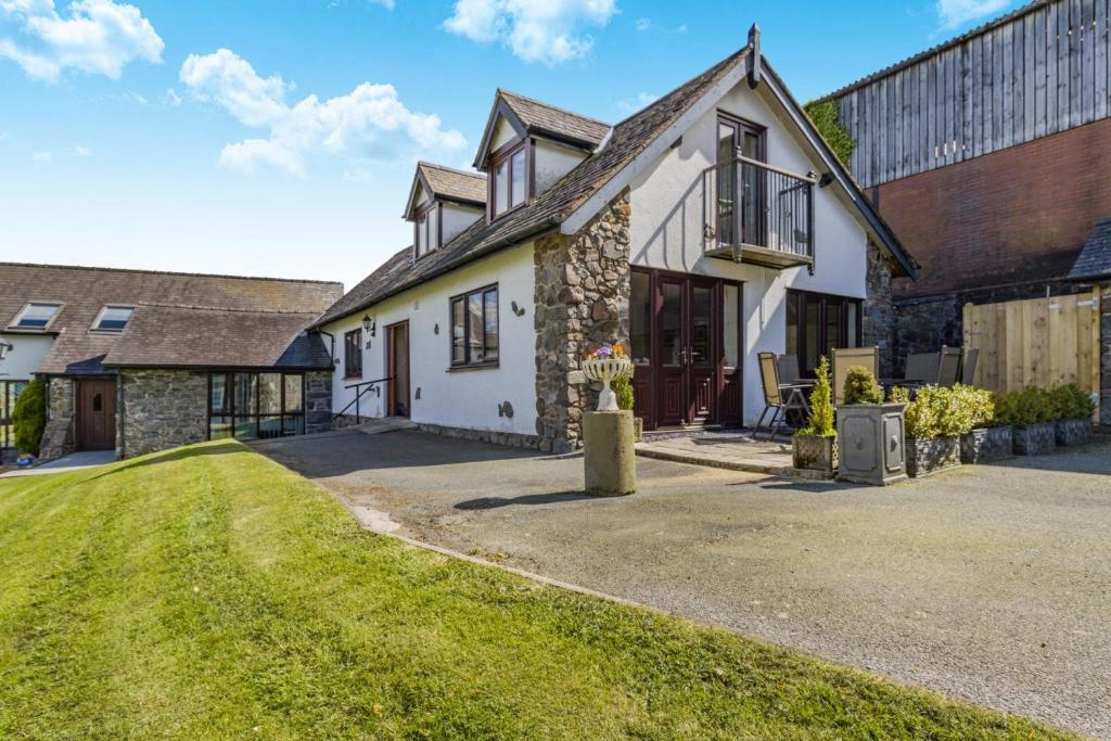 a house with a grassy yard in front of it at 4 Bed in Caersws oc-waa321 in Trefeglwys