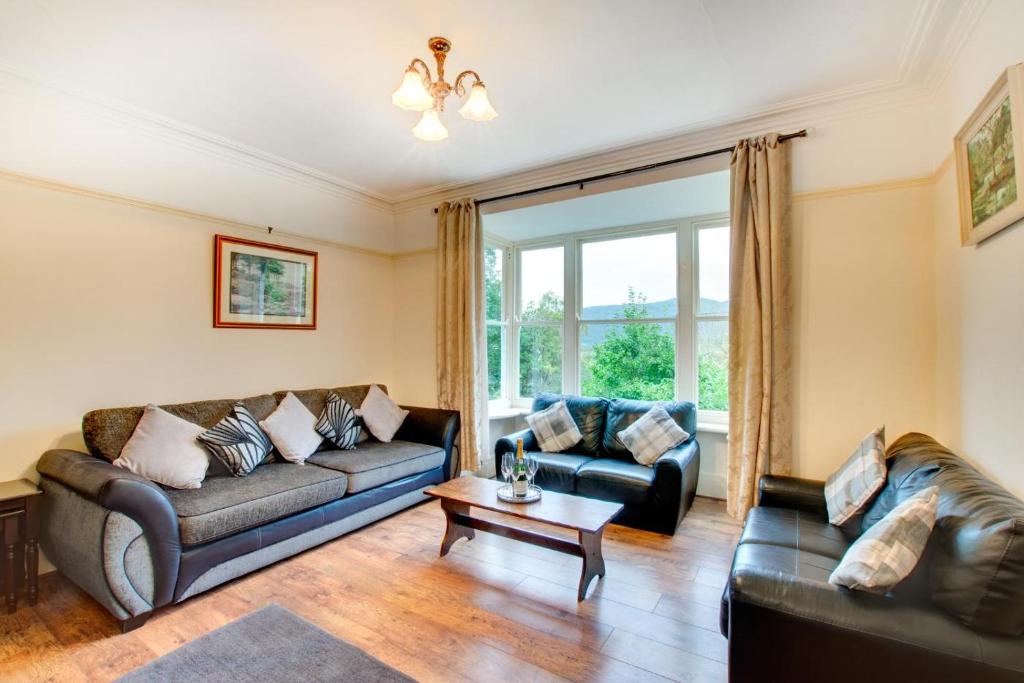a living room with two couches and a table at 6 Bed in Dolgellau oc-wah675 in Arthog