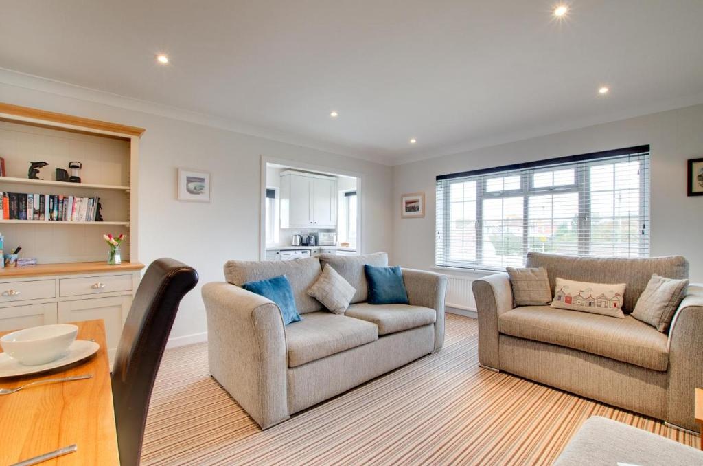 a living room with two chairs and a table at 2 Bed in Swanage oc-wy344 in Swanage