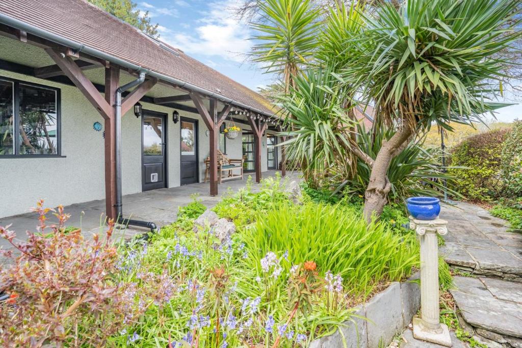 a garden in front of a building with a blue bowl at 1 Bed in Mumbles oc-hh631 in Oystermouth