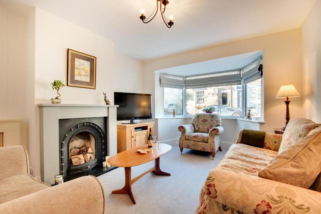a living room with a couch and a fireplace at 4 Bed in Masham oc-ds1007 in Masham