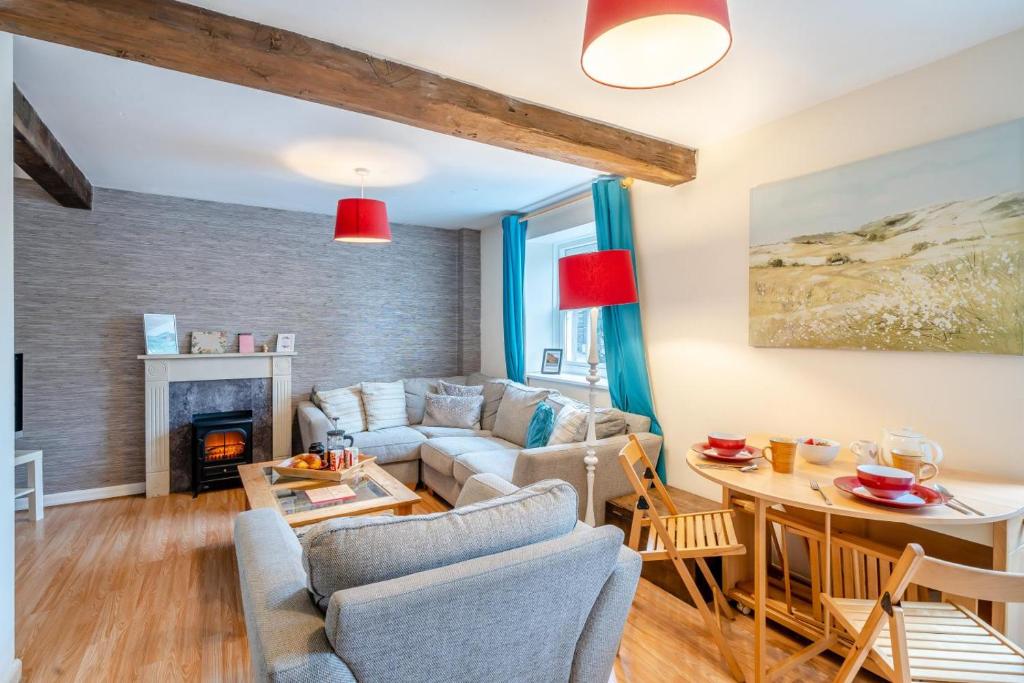a living room with a couch and a table at 2 Bed in Kendal oc-gl097 in Kendal