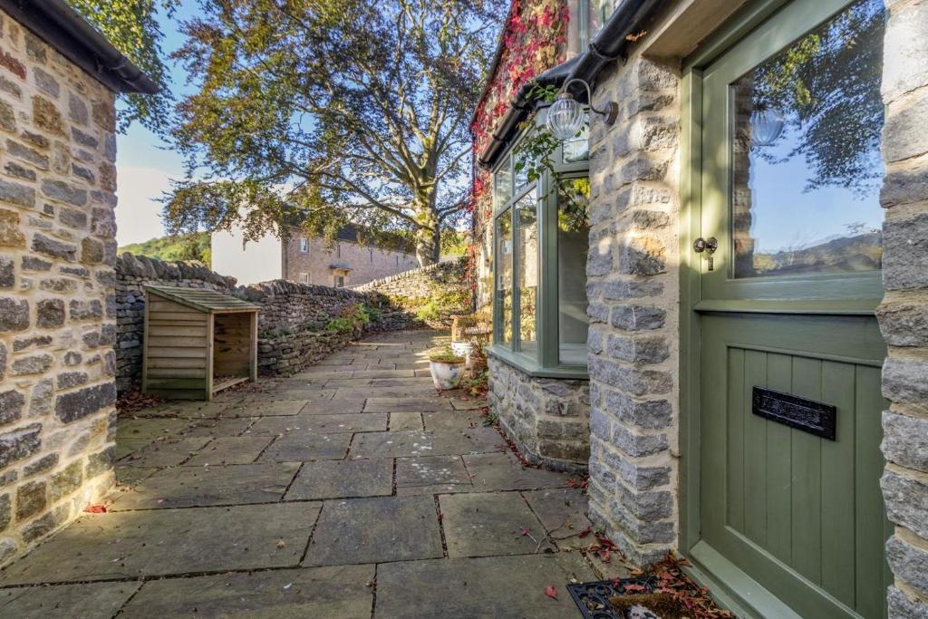 a door to a house with a stone walkway at 3 Bed in Calver oc-h33087 in Curbar