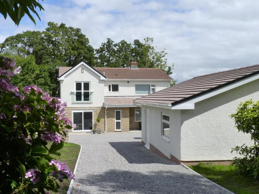 a large white house with a driveway at 4 Bed in Swansea oc-hh642 in Oystermouth