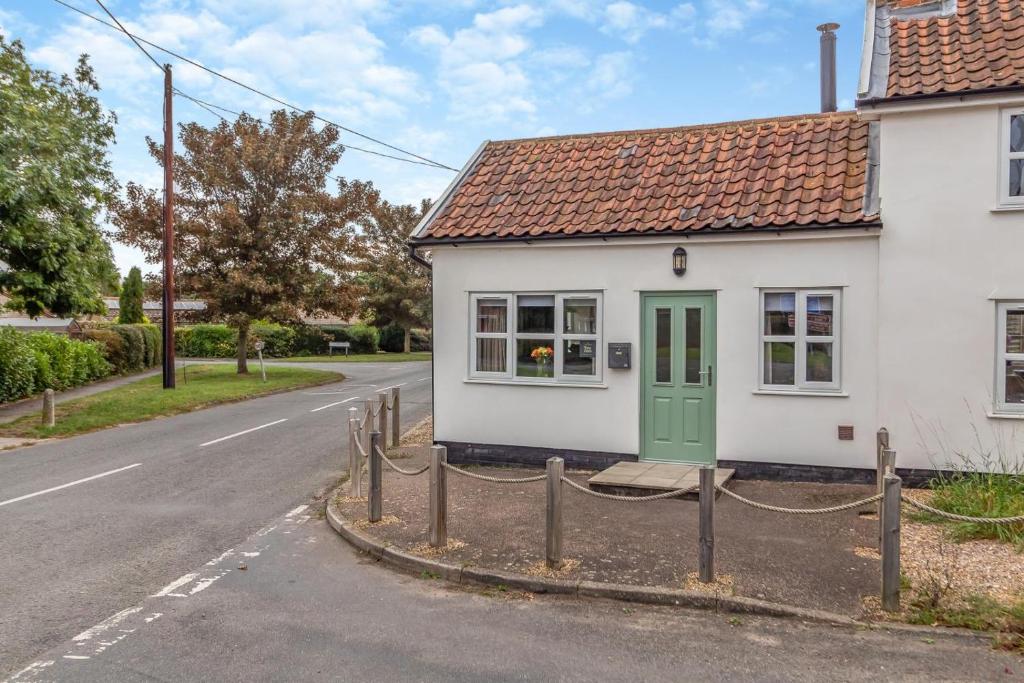 a small white house with a green door on a street at 2 Bed in Bentley oc-thpo in Bentley