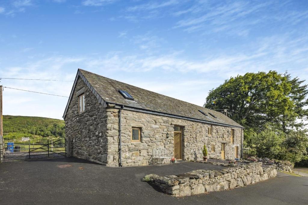 an old stone barn with a stone wall at 2 Bed in Bala oc-82768 in Llandderfel