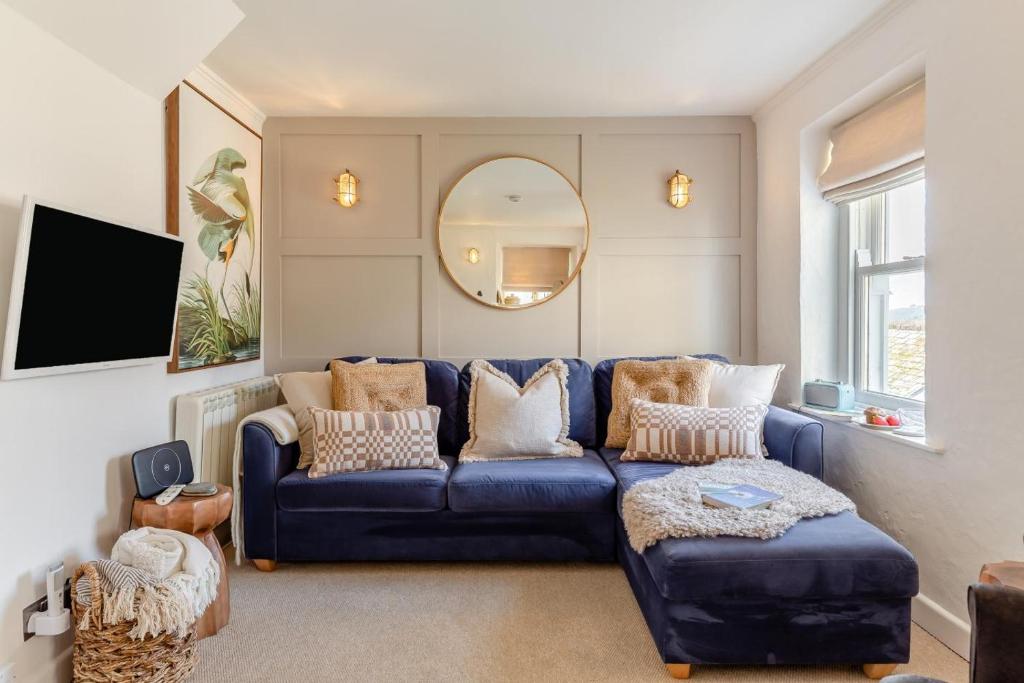 a living room with a blue couch and a mirror at 2 Bed in St. Ives oc-p00568 in St Ives