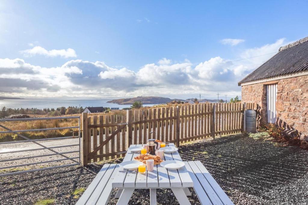 a picnic table in front of a wooden fence at 2 Bed in Big Sand oc-d33686 in Big Sand