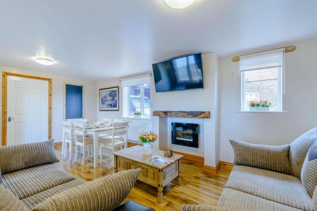 a living room with two couches and a fireplace at 2 Bed in Dunnington oc-s34137 in Dunnington