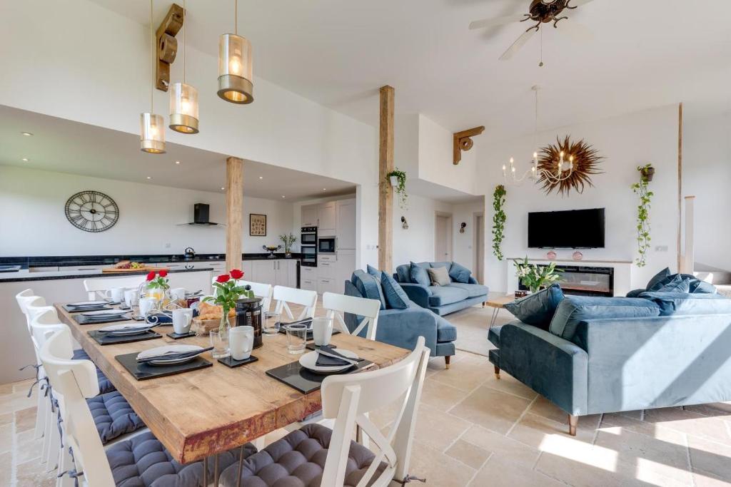 a dining room and living room with a table and chairs at 5 Bed in Briston oc-2305 in Briston