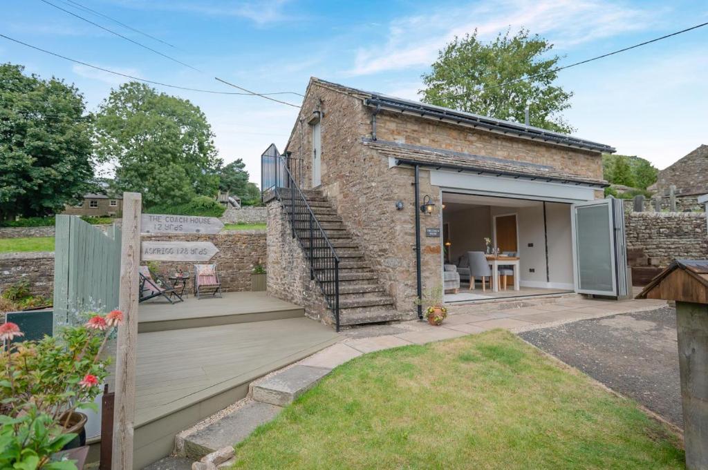a small brick building with a deck and a patio at 1 Bed in Askrigg oc-c33109 in Askrigg
