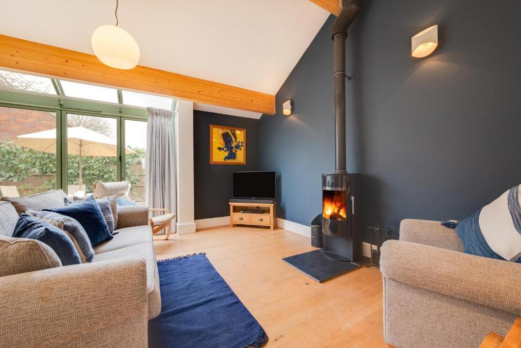 a living room with a couch and a fireplace at 2 Bed in Holt oc-2274 in Holt