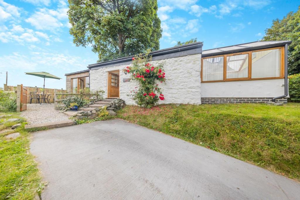 a small white brick house with a driveway at 1 Bed in Llanrwst oc-wag696 in Llanrwst
