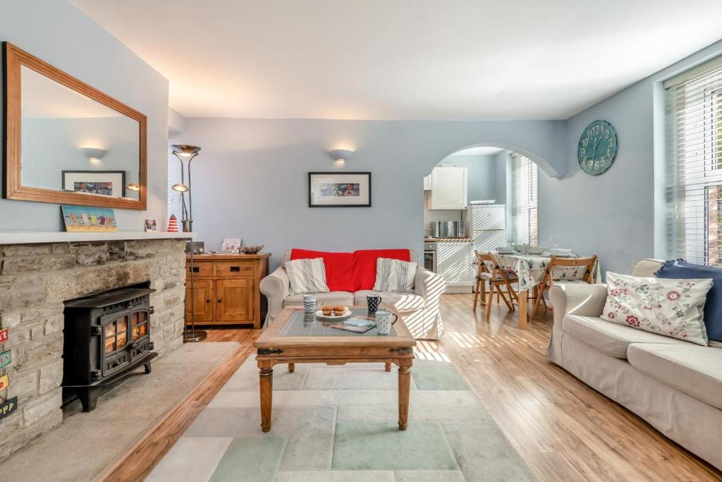 a living room with a couch and a fireplace at 3 Bed in Swanage oc-wy272 in Swanage