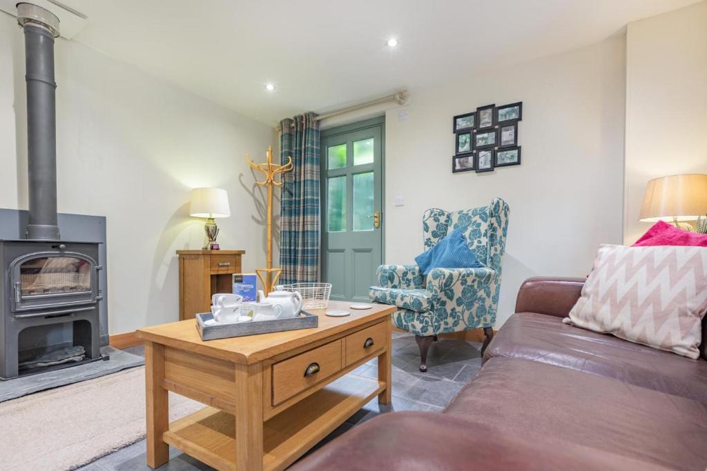 a living room with a couch and a wood stove at 1 Bed in Bodmin oc-p00438 in Bodmin