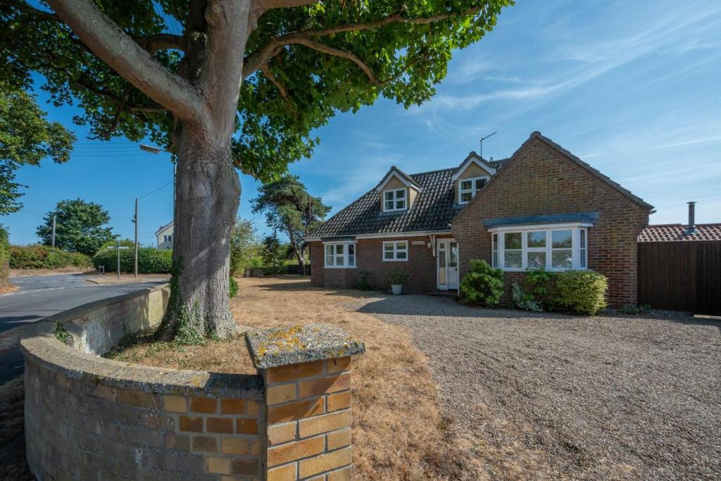 a house with a tree in a brick wall at 4 Bed in Southwold oc-spn in Reydon