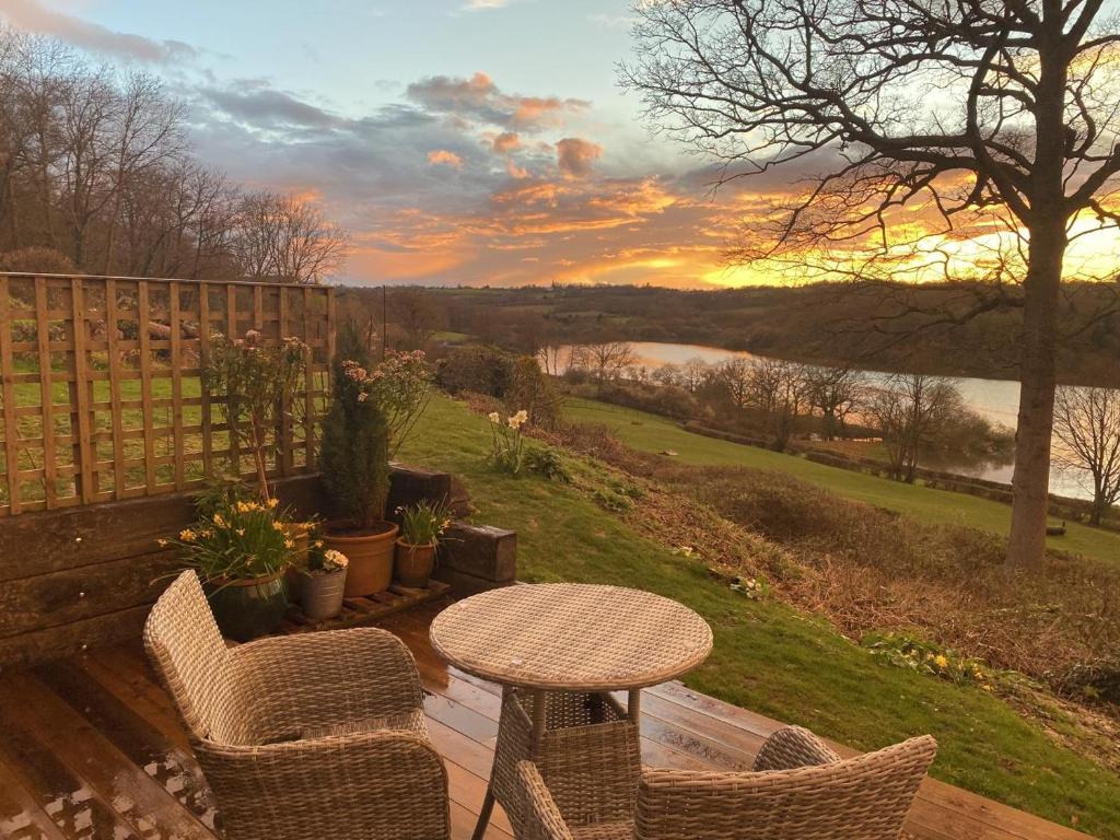 a patio with a table and chairs and a view of a river at 1 Bed in Wadhurst oc-tw673 in Wadhurst