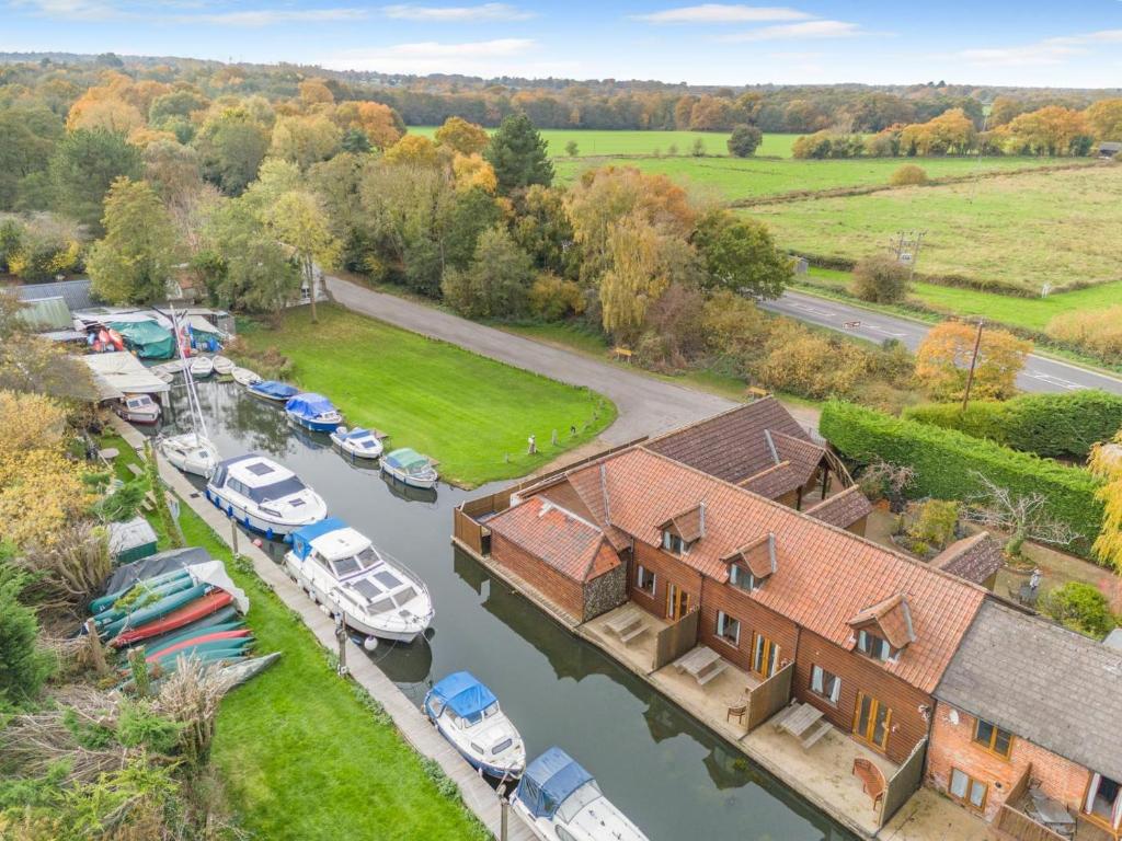 an aerial view of a house with boats in a marina at 2 Bed in Smallburgh oc-g33735 in Dilham