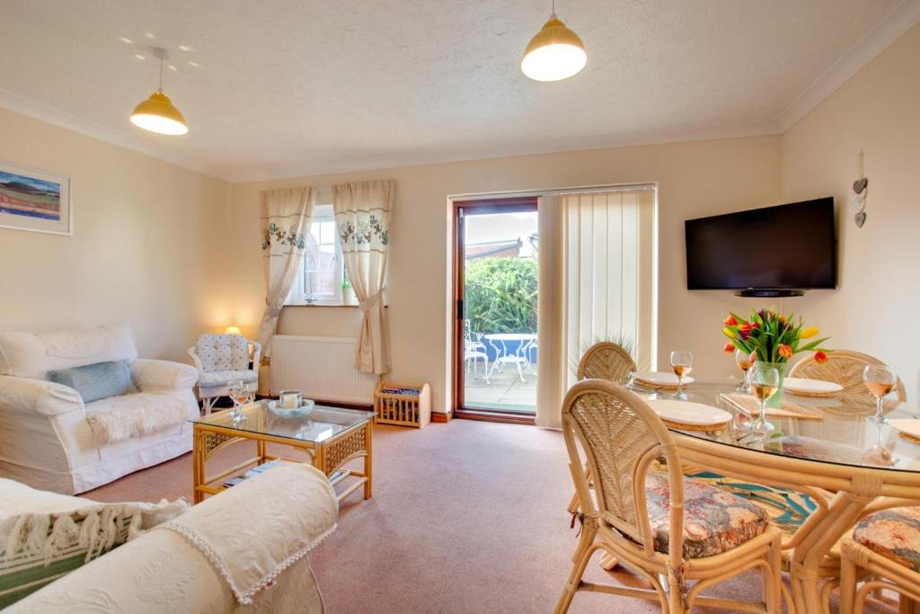 a living room with a couch and a table at 2 Bed in Sheringham oc-2029 in Sheringham