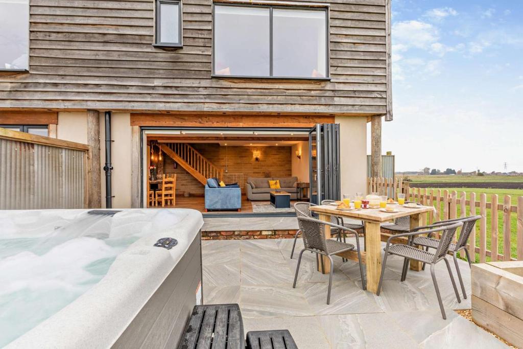 a house with a pool and a table and chairs at 3 Bed in Outwell oc-b28260 in Upwell
