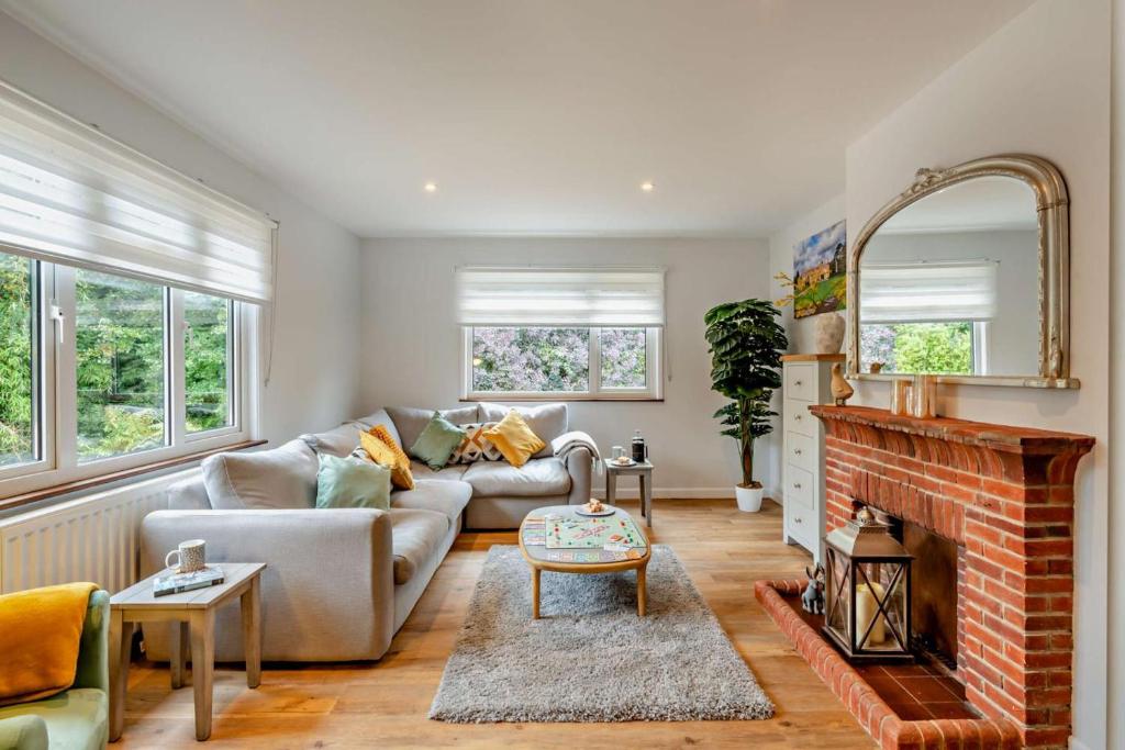 a living room with a couch and a fireplace at 3 Bed in Acton oc-c28929 in Waldingfield