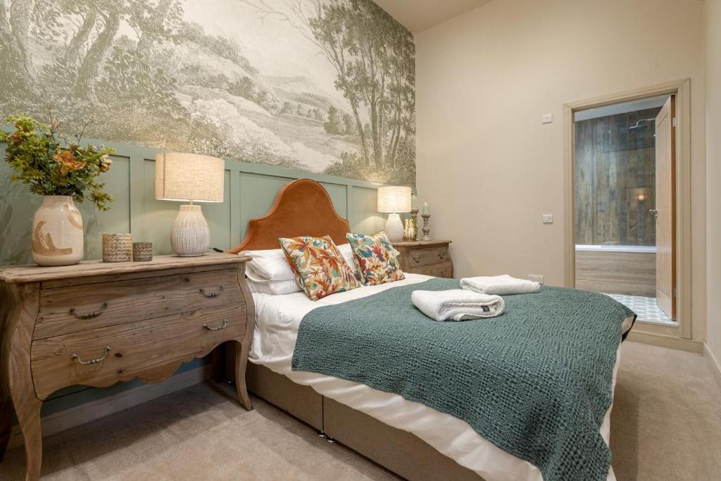 a bedroom with a bed with a table and a painting at 1 Bed in Wycliffe oc-t29946 in Wycliffe