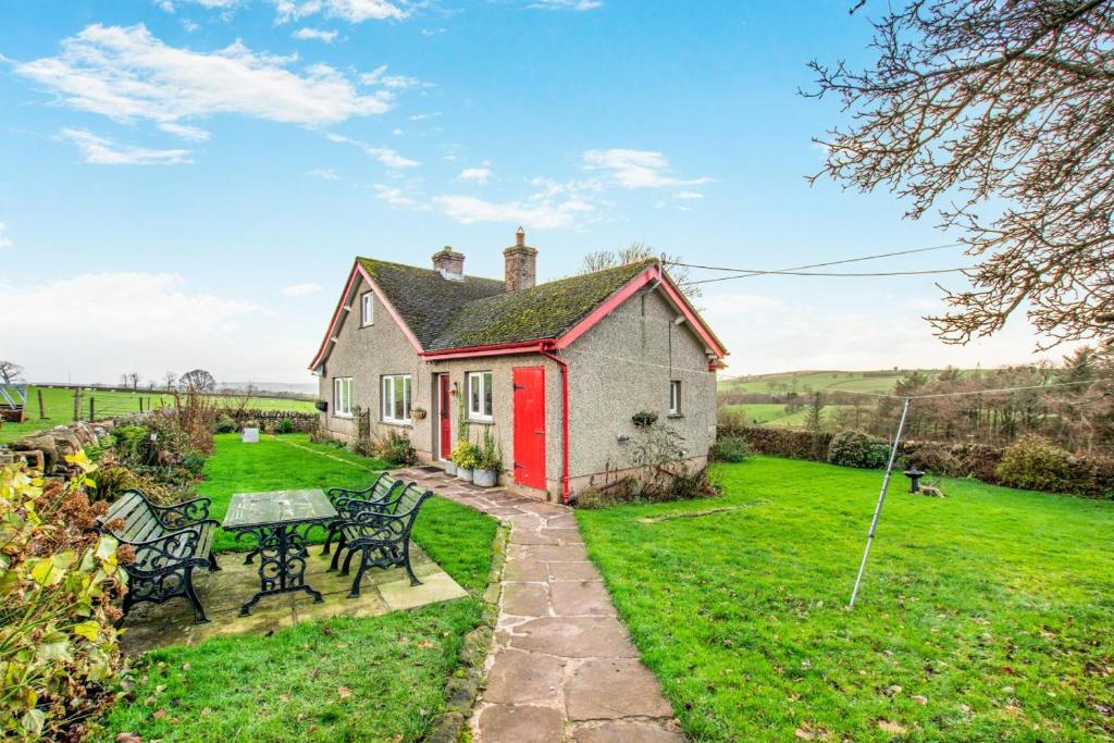 a red and white house with a table and chairs at 2 Bed in Renwick oc-h34195 in Renwick