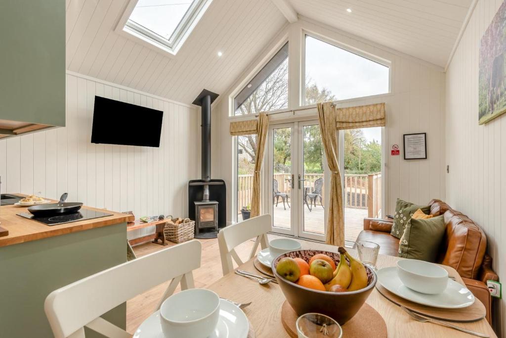 a dining room with a table with a bowl of fruit at 2 Bed in Mouswald oc-b33444 in Mouswald