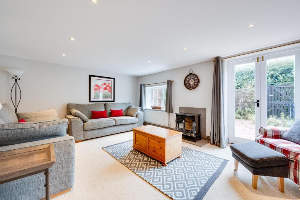 a living room with a couch and a fireplace at 4 Bed in Halesworth oc-5river in Halesworth