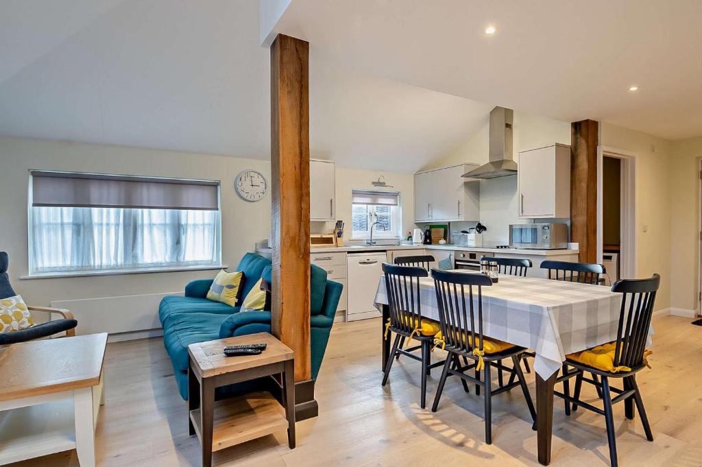 a kitchen and living room with a blue couch at 2 Bed in Wickhambrook oc-b30507 in Wickhambrook