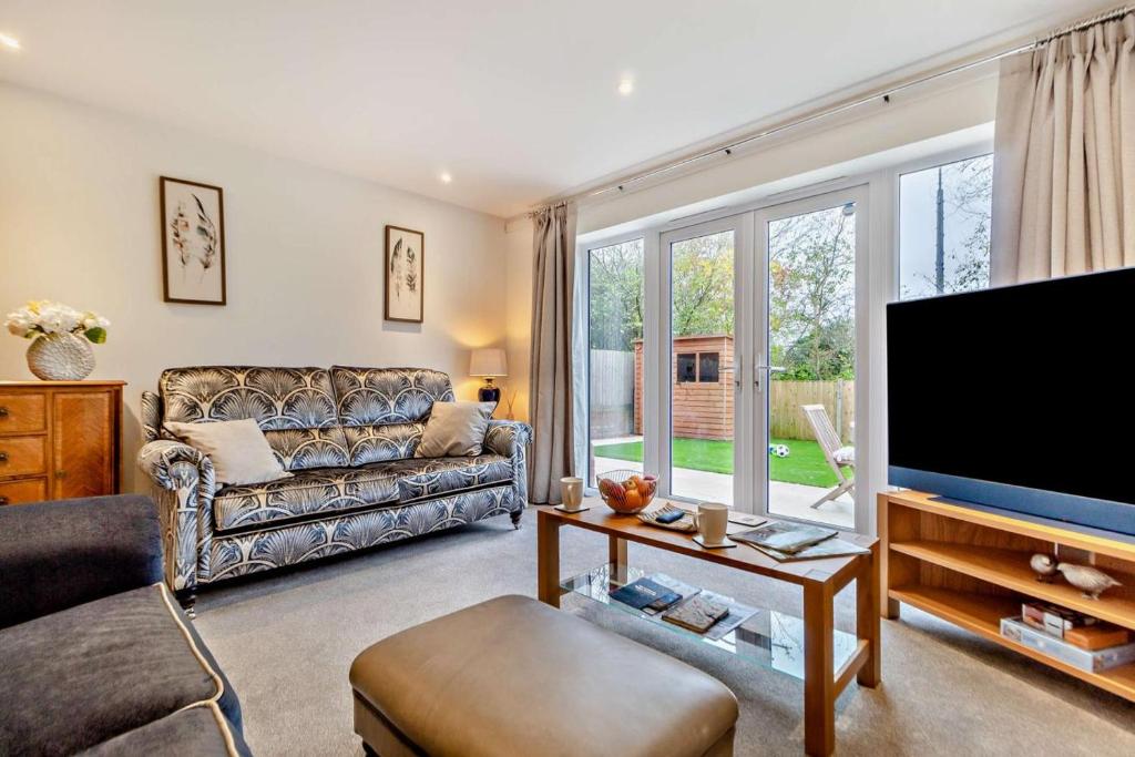 a living room with a couch and a flat screen tv at 3 Bed in Framlingham oc-f30353 in Framlingham