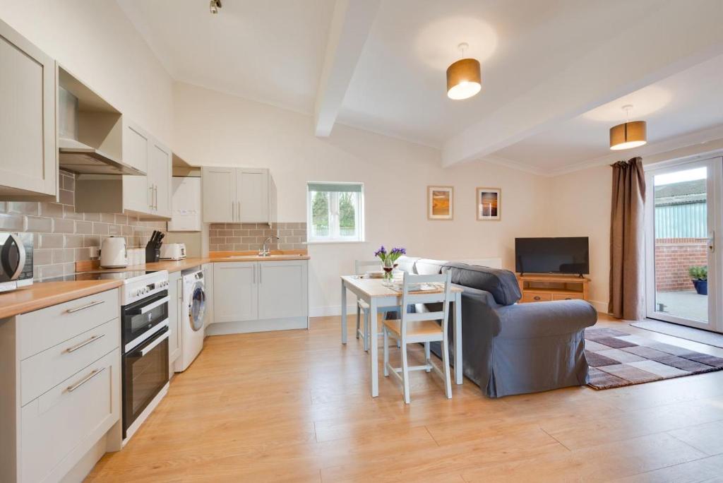 a kitchen and living room with a table and a couch at 1 Bed in Chedgrave oc-2250 in Chedgrave