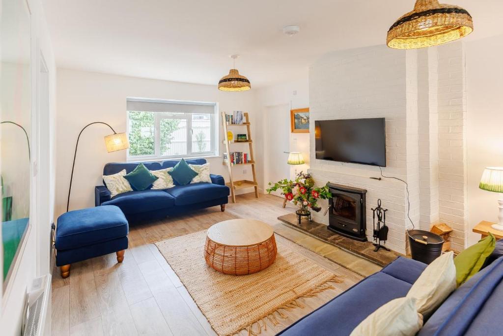 a living room with a blue couch and a fireplace at 3 Bed in Camber oc-s27568 in Camber