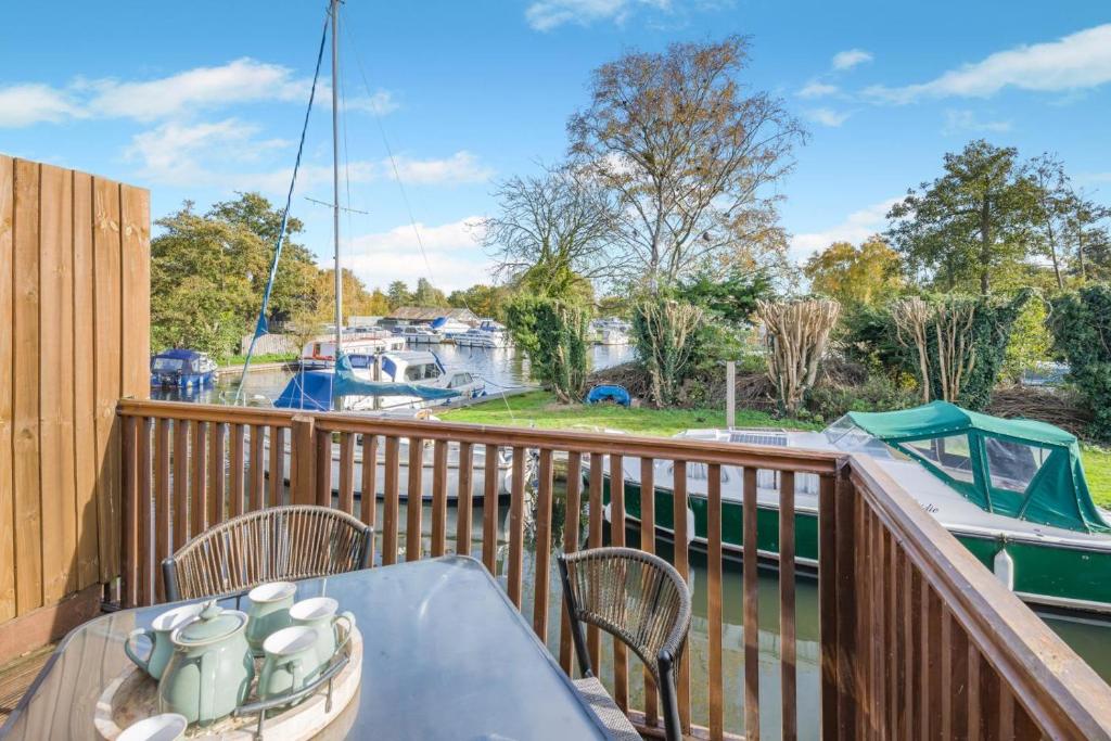 a balcony with a table and chairs and a boat at 2 Bed in Smallburgh oc-m33732 in Dilham