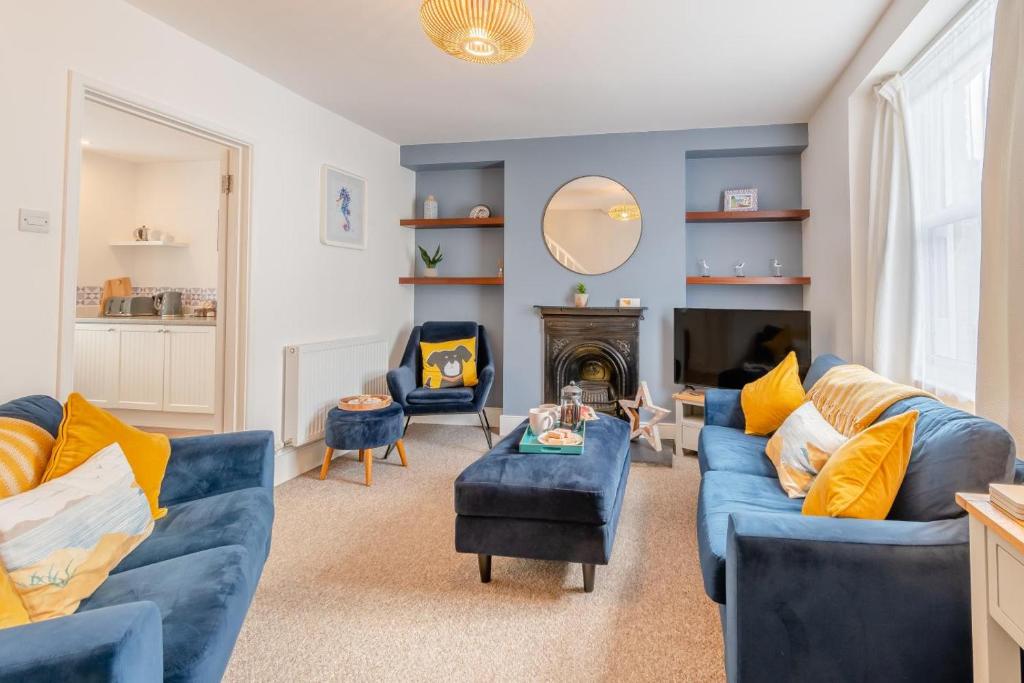 a living room with blue couches and a fireplace at 2 Bed in Tenby oc-pw1031 in Tenby